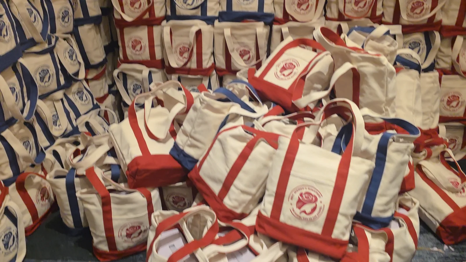 The gift-bag wall, as filmed on a phone and as it appears in the film with the 400+ numeral