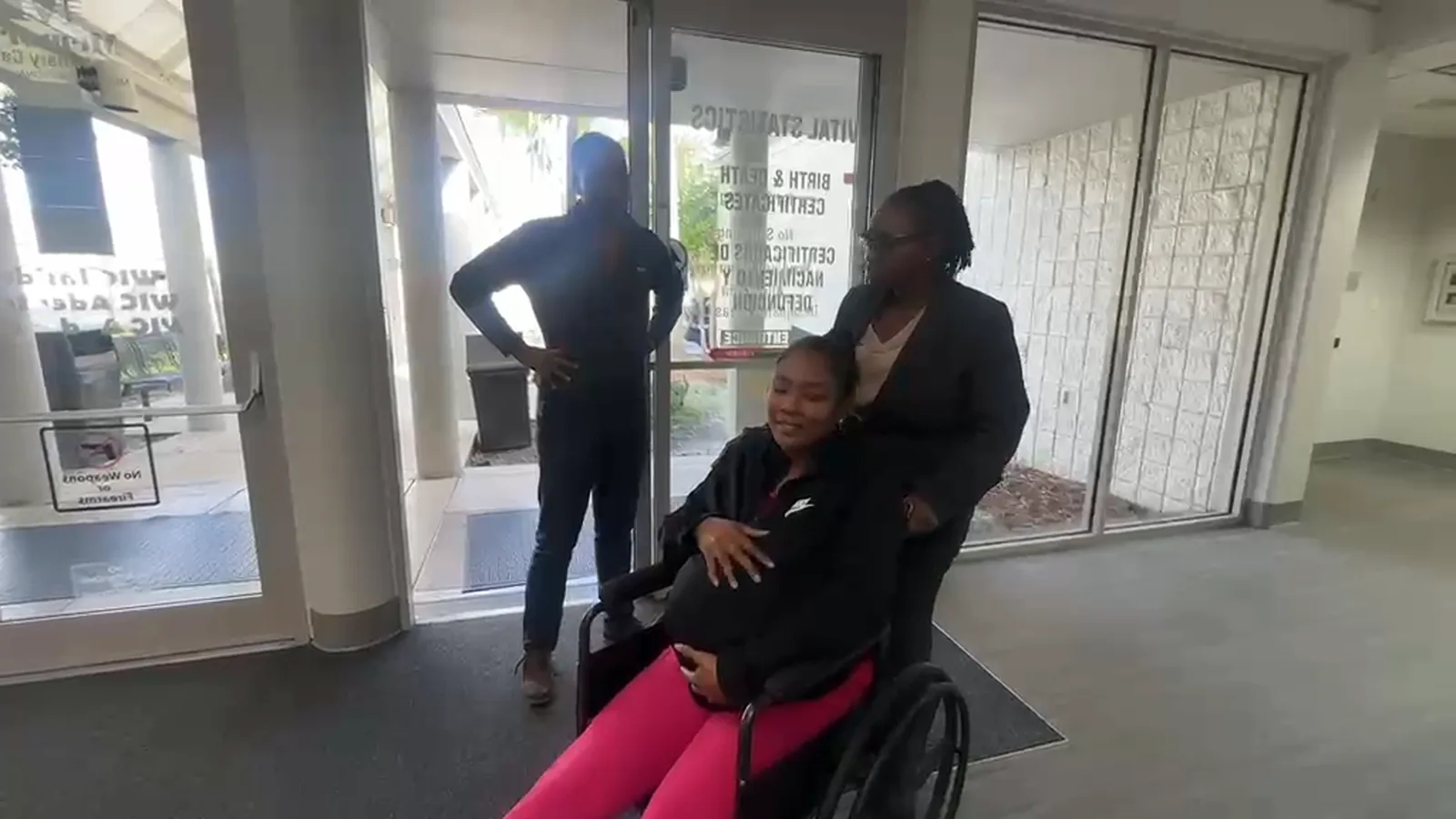 The patient arriving in a wheelchair, as filmed on a phone and as it appears in the film with the ‘Best team ever’ graphic