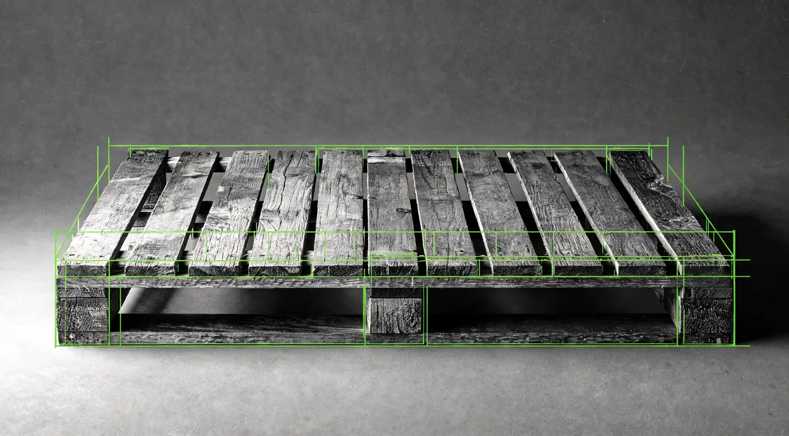 An empty wooden pallet on a studio floor with measurement lines along its edges